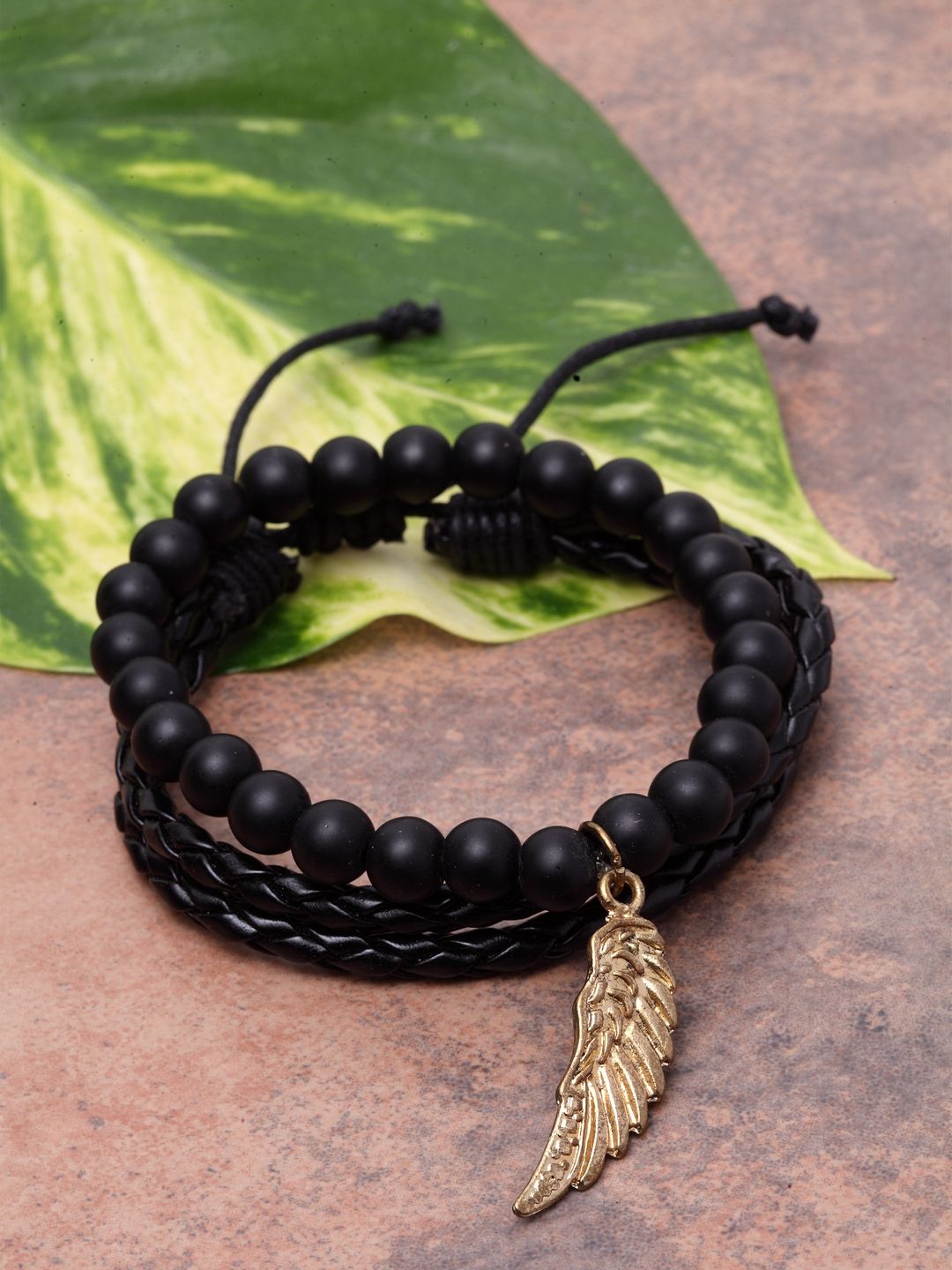 Black leather bracelet with silver clasp and golden accessories 